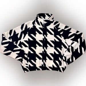 Move Theology cozy full-zip fleece with a black and white houndstooth pattern